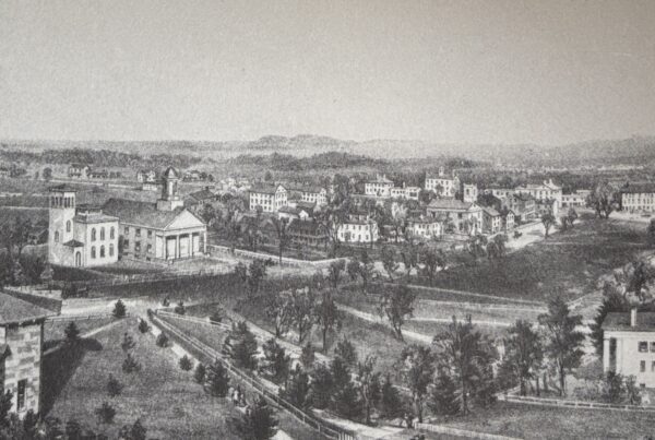 Historic black-and-white illustration of a 19th-century town with scattered buildings and tree-lined roads, evoking a quiet, introspective atmosphere. Used to reflect the internal isolation and psychological landscape explored in Emily Dickinson’s poem 'I felt a Funeral in my Brain.'